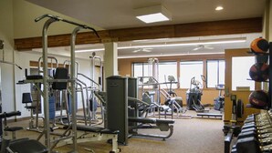 A gym with various exercise equipment, including weight machines, treadmills, and free weights. - Dog-friendly condo close to Winter Park shuttle with pool, hot tub, tennis, gym (Fraser)