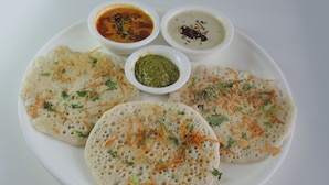 A plate with three dosas and two chutneys. - DIVYA LODGE & HOTEL ROOMS (Hyderabad)