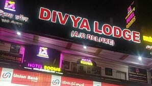 A hotel named DIVYA LODGE (A/C DELUXE) with multiple signs indicating hotel rooms and a Union Bank branch. - DIVYA LODGE & HOTEL ROOMS (Hyderabad)