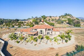 Situated on a hillside, this single-story home offers a view of the surrounding hilly landscape.