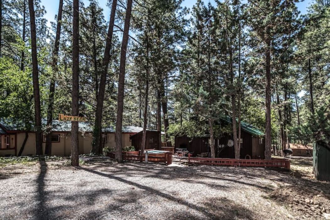 A forested area with cabins and a sign that reads "Lazy Bear."