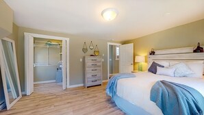 A bedroom with a bed, a dresser, a walk-in closet, and a ceiling light. - Cozy Waterfall Home | Close to All Mountains/Hikes (East Durham)
