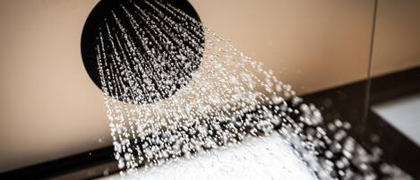 A showerhead with water spraying down.