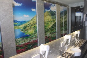 A bathroom with a large mirror, a sink, and two hair dryers. - H-District Boutique Poshotel (Bangkok)