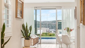 A modern hotel room with a balcony, a dining area, and a view of the landscape. - Resort-like residence with pool, jacuzzi, sauna, ocean breeze & amazing sunsets (Mission Viejo)