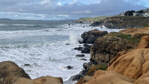 A coastal landscape with rocky terrain and a view of the ocean. - Unobstructed ocean views in a cozy setting (Dillon Beach)