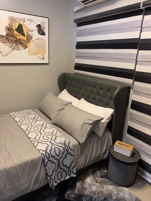 Laptop workspace, bed sheets