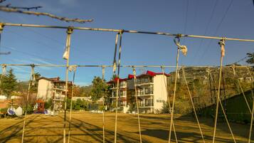 A residential building with multiple balconies and a red roof.