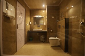 A compact bathroom with a toilet, sink, and shower. - Golden Wood Manali By Rosetum (Manali)