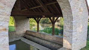 A stone structure with a wooden roof, a small pool, and steps leading down to the water. - Large House with Private Pool and Valley View (Savigny-sur-Grosne)
