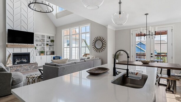 A modern kitchen with a central island, a built-in oven, and a dining area with a bench. - Beautiful Lake Home Retreat with Lake and Marina Access and Golf Cart (Winchester)