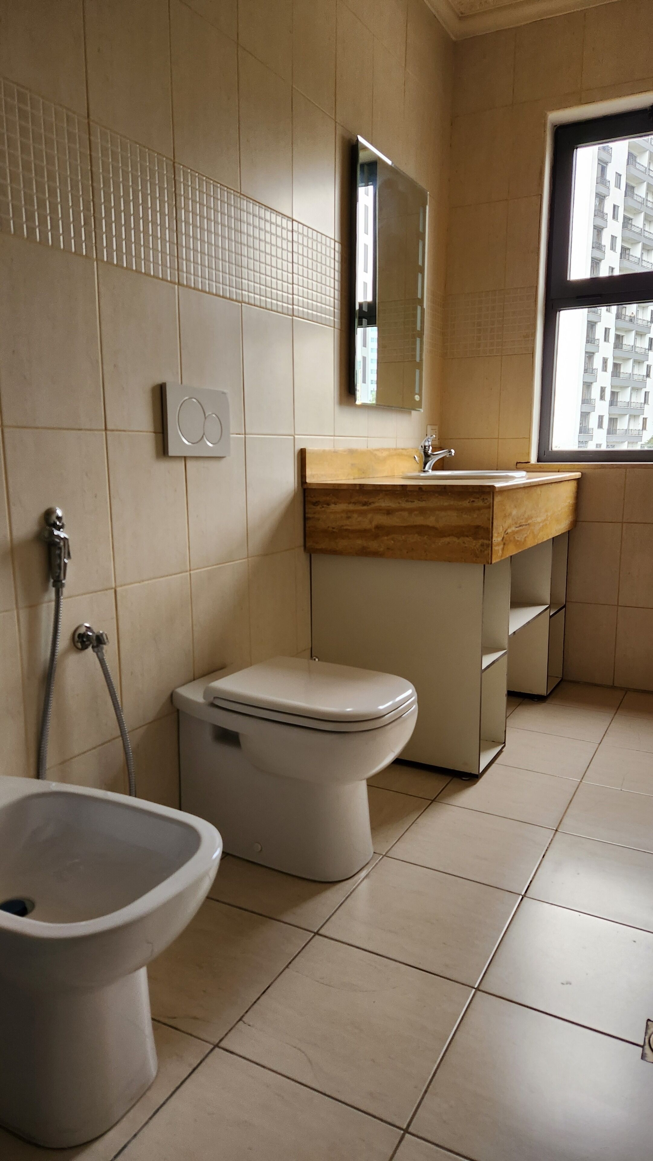 A bathroom with a toilet, bidet, and sink.