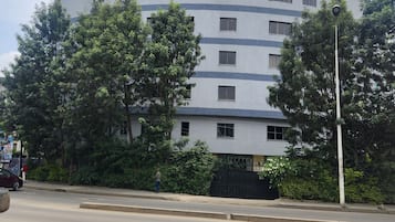 A multi-story building with a curved facade, numerous windows, and balconies.