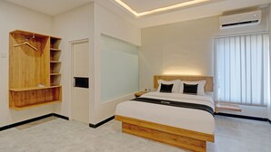 A modern bedroom with a wooden bed frame, a built-in wardrobe, and a bedside table.