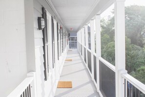 Stroll through this traditional corridor, lined with white-framed windows and doors, and exit to the great outdoors.