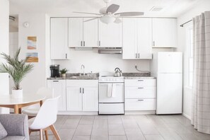 Fully equipped kitchen with stove, oven, and refrigerator, perfect for cooking and dining.