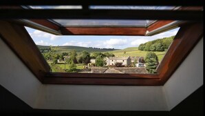 A skylight with a view of a rural landscape including houses and greenery. - Perfect for  all large groups in 7 all ensuite bedrooms . Pet friendly (Buxton)