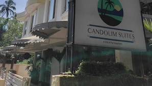 A multi-story hotel with balconies and a sign for Candolim Suites. - Candolim Suites (Candolim)