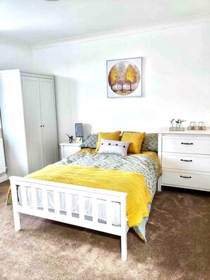 Cozy retreat with a four-poster bed, nightstand, and dresser, perfect for a restful stay.