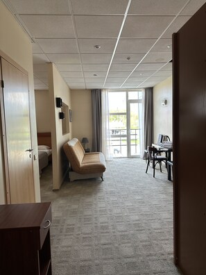 Standard Quadruple Room | Living area | 80-cm plasma TV with satellite channels, TV - Unimars Hotel Riga (Riga)