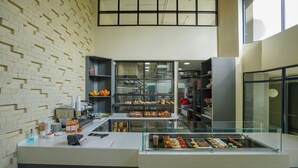 A bakery with a display case of pastries and a counter with a cash register. - Warwick Centre (Nairobi)