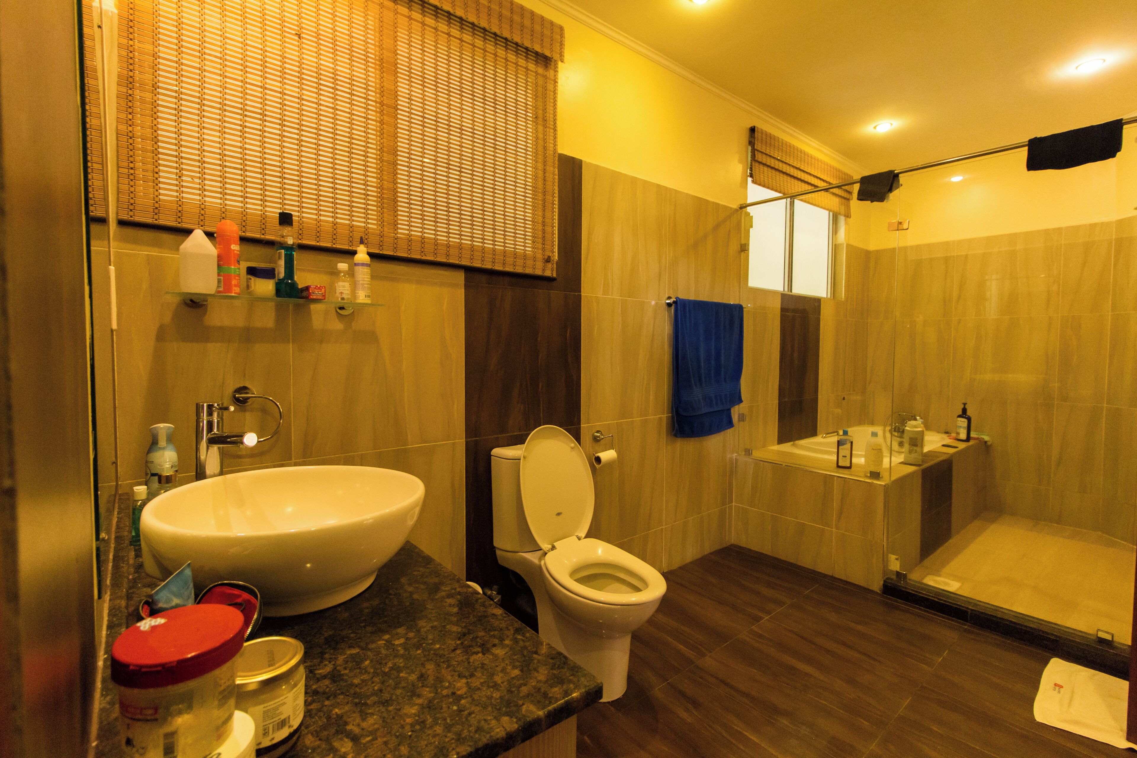 A modern bathroom with a large sink, toilet, and shower.