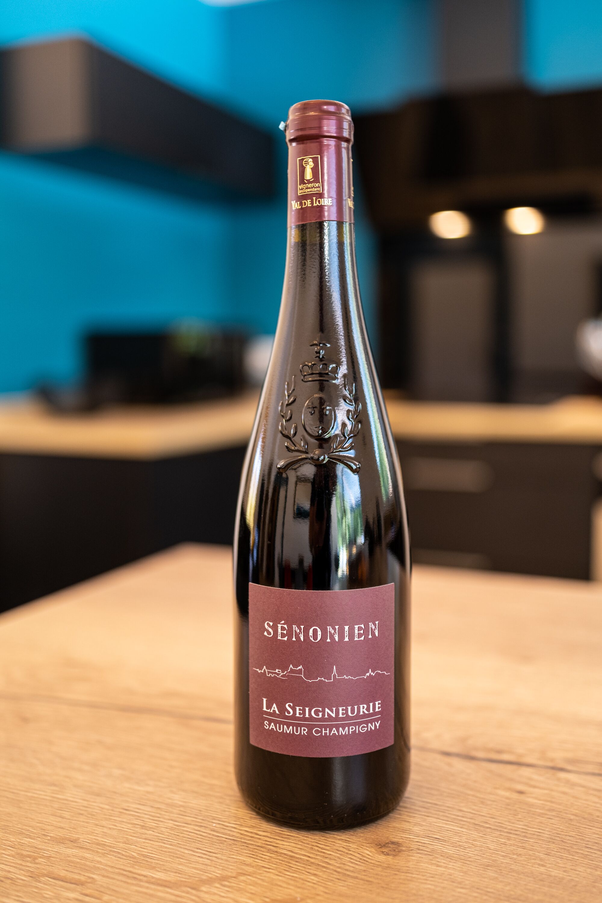 A bottle of wine with a label that reads "SÉNONIEN La Signeurie SAUMUR CHAMPIGNY."