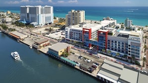 An aerial view of a coastal city with high-rise buildings, a marina, and a bridge connecting two areas. - Costa Hollywood Beach Studios (Hollywood)