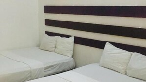 A hotel room with two single beds and a larger bed, all with white linens. - Caribbean Hotel Santo Domingo (Santo Domingo)