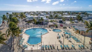 A resort with multiple swimming pools, palm trees, and beach views. - Cozy Venture Out Cottage (Cudjoe Key)