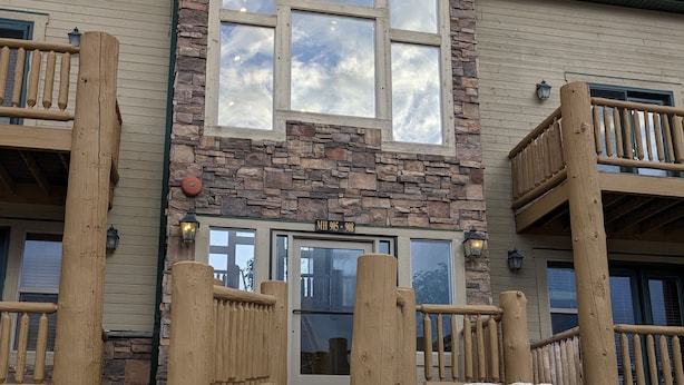 A two-story building with a stone facade, large windows, and a wooden balcony. - Eden/Powder Mountain/Snowbasin: mountain getaway, skiing, hiking, biking, golf (Eden)