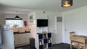 A compact living space with a kitchenette, a dining area, and a seating area. - M & T Chalets , 2 bed chalet Hemsby. sleeps 6 (great yarmouth)