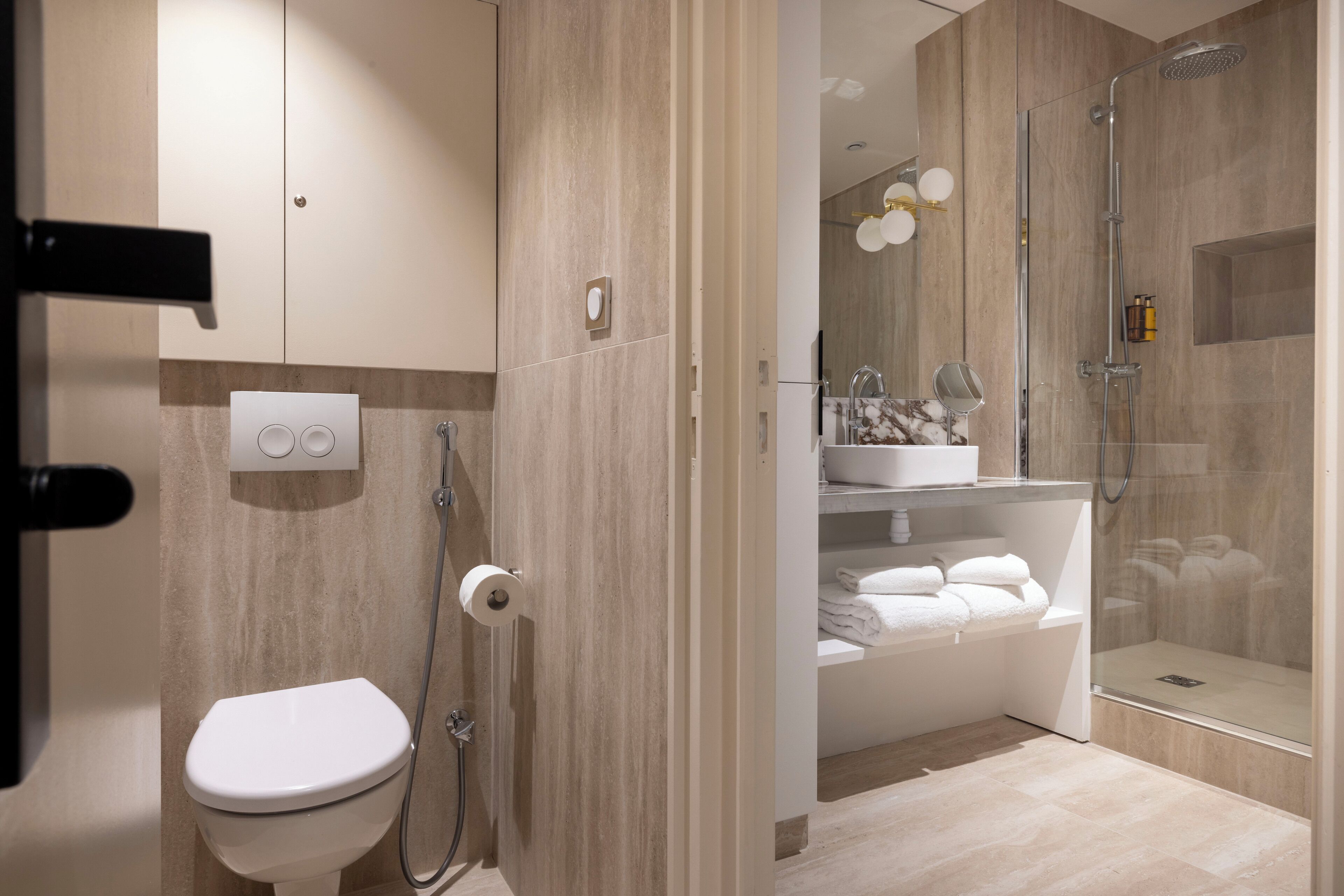 A modern bathroom with a toilet, shower, and bathtub.