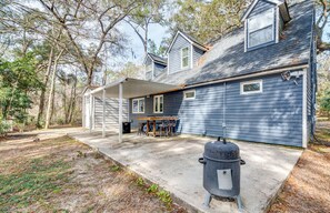 A two-story house with a covered patio, a barbecue grill, and a dining area with outdoor furniture. - 4 Mi to UF: Pet-Friendly Home w/ Yard & Deck (Gainesville)