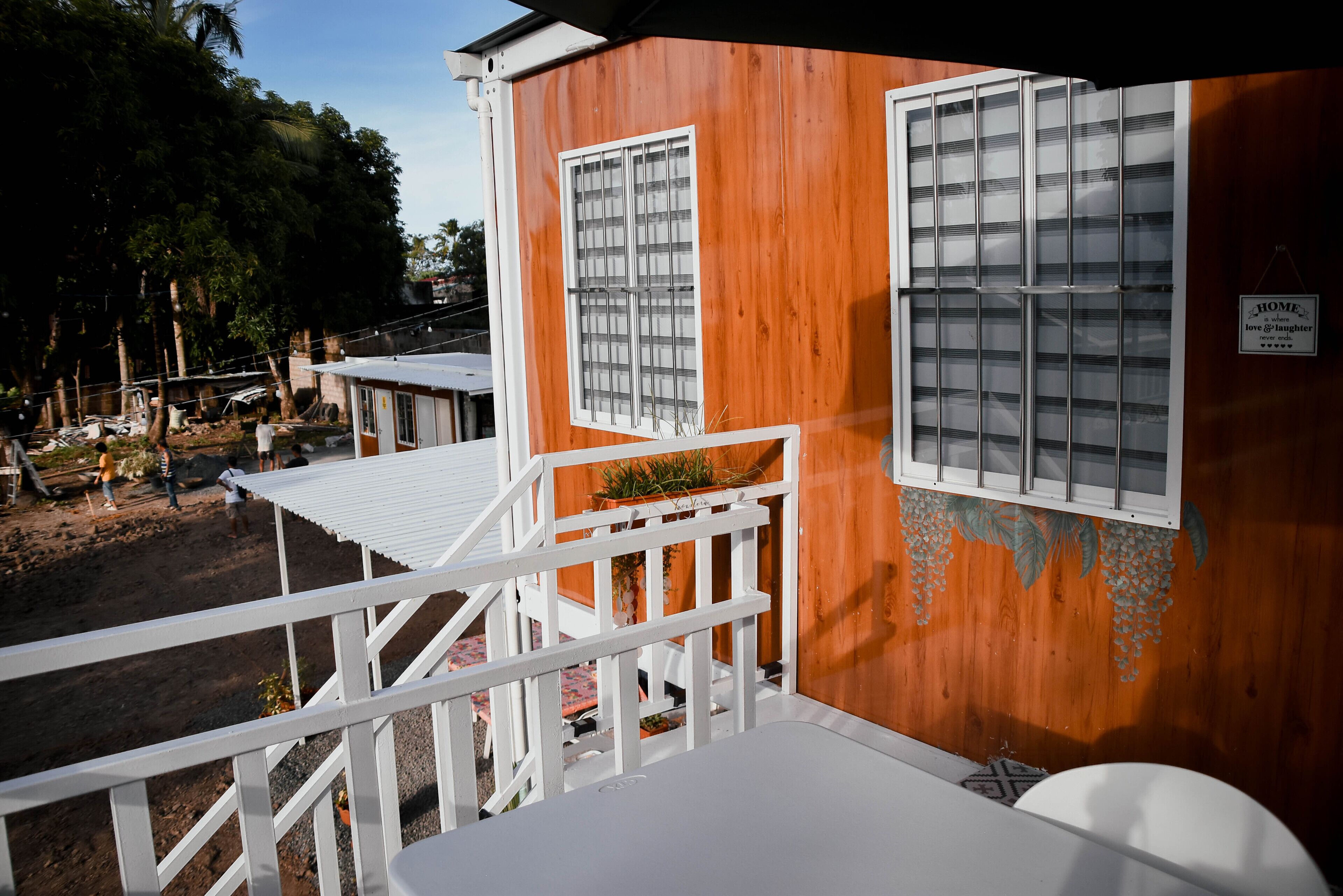 A wooden cabin with white railings and a small porch.
