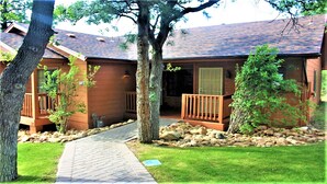 A two-story wooden house with a stone pathway leading to the entrance. - 2Bed/2Bath Deluxe Unit in Flagstaff! Complete w/Golf, Pools, and More! (Flagstaff)