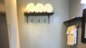 A small bathroom with a toilet, sink, and towel rack.