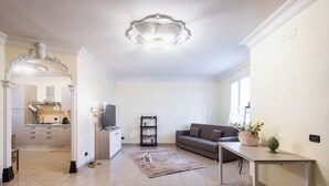 A modern living room with a sofa, a coffee table, a rug, and a television. - Casa Amica - Three Bedroom House, Sleeps 6 (Avola)
