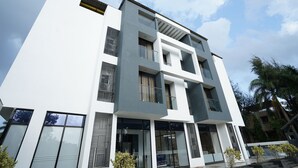 A modern multi-story building with large windows and balconies. - CIESTA TREEO (Mawal)