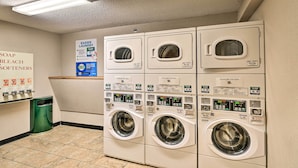 A laundry facility with multiple washing machines and a soap and bleach sign. - Ski-In/Ski-Out Crested Butte Studio w/ Pool Access (Crested Butte)