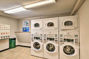 A laundry facility with multiple washing machines and a sign indicating the availability of soap, bleach, and softeners. - Ski-In/Ski-Out Crested Butte Studio w/ Pool Access (Crested Butte)