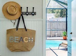 A beach-themed wall hanging with a straw hat and a 'BEACH' tote bag. - Hip Nautic Gulfport Retreat min to St Pete/Beaches (Gulfport)