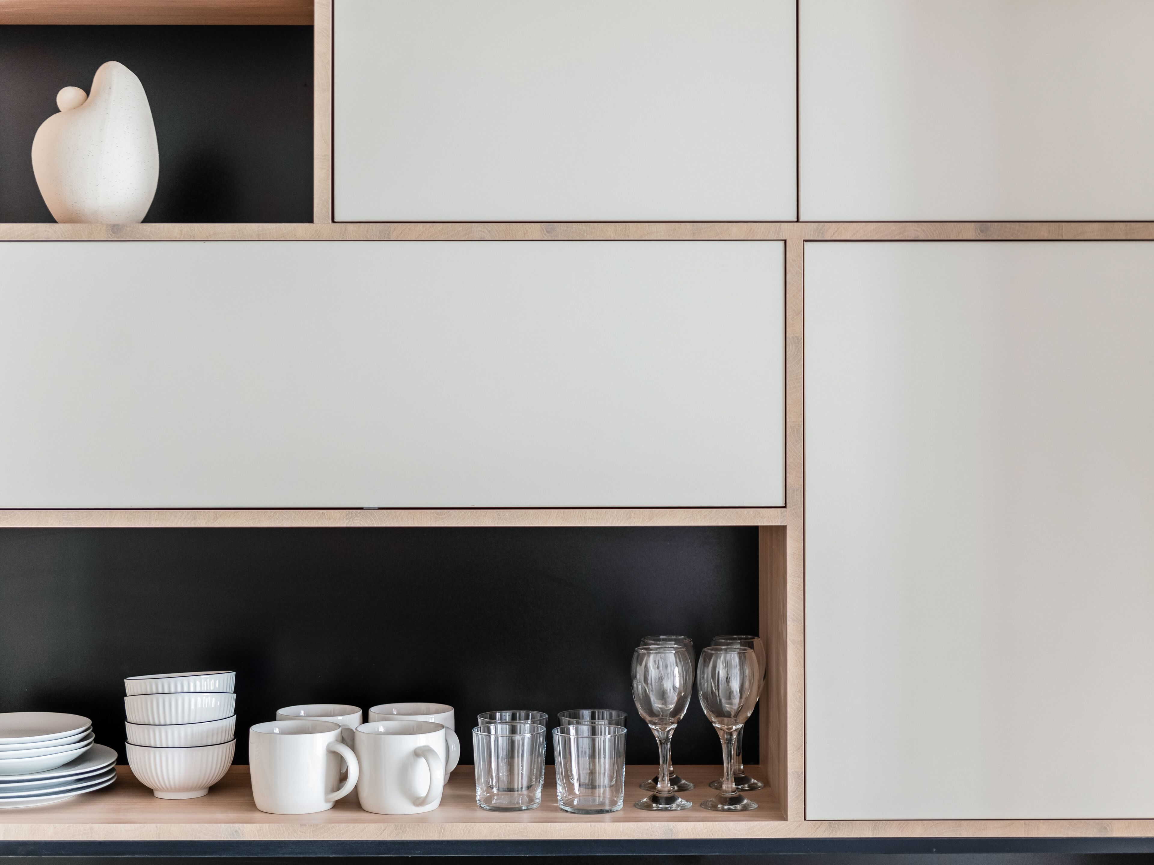 A kitchen with wooden cabinets and a black countertop.