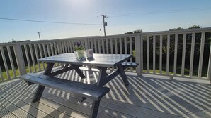 A wooden deck with a picnic table and bench, surrounded by a white fence. - Coast Road Cottage, Carnivan, Fethard on Sea, Wexford (Fethard On Sea)