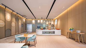 A modern cafe with a central counter, light wood paneling, and a minimalist design.