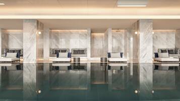 Relax in a spacious lobby with clean lines and minimalist design, featuring comfortable seating areas and elegant finishes.