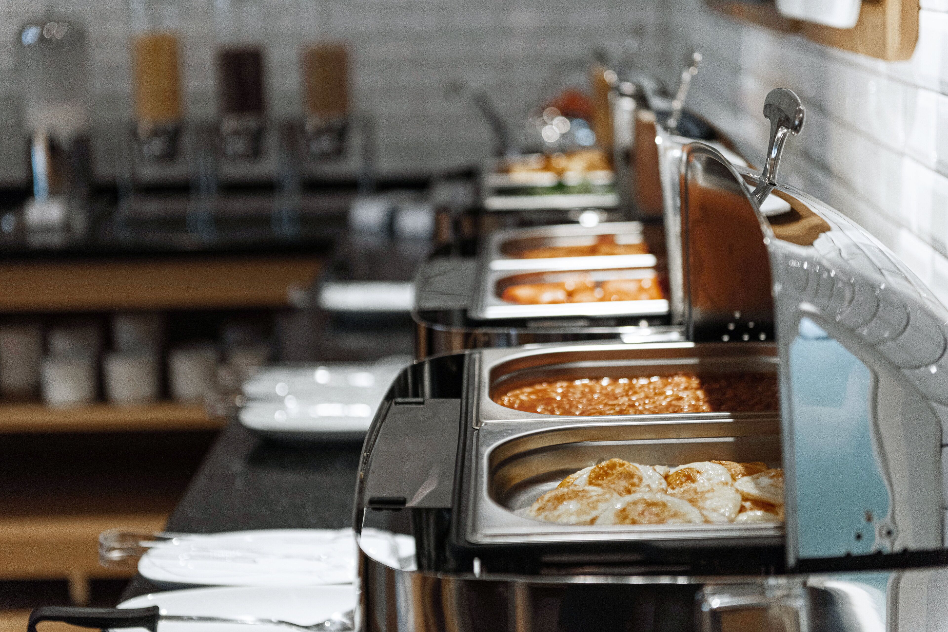 A buffet setup with multiple serving stations, each with a variety of food options.