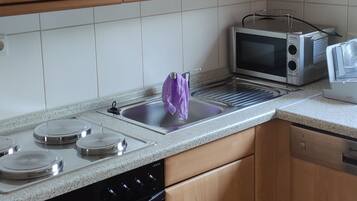 Stovetop, electric kettle, cookware/dishes/utensils, dining tables