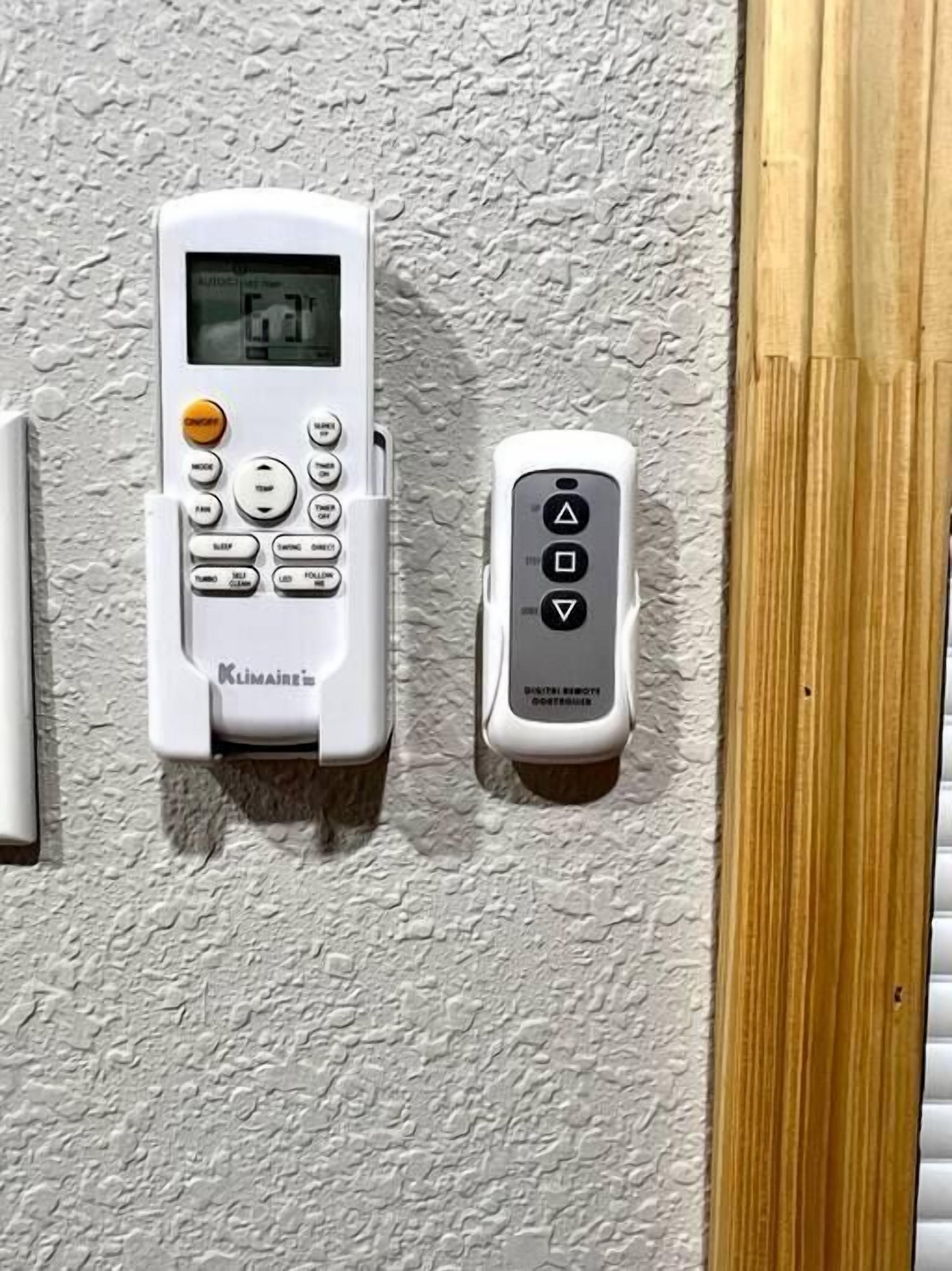A wall-mounted thermostat and remote control.