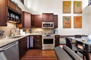 Enjoy cooking in this well-equipped kitchen with a large island, oven, and ample counter space.